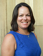 board member with dark hair and blue top