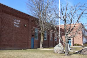 Crispell Middle School brick building with blue doors