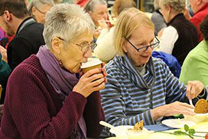 Two women enjoy dessert at the annual senior citizen dinner