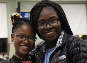 Two girls smile for the camera