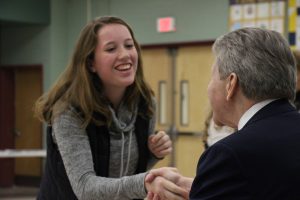 girl shaking superintendent's hand