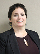 head shot of a woman with short dark hair smiling