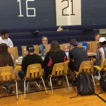 high school students sit as they register for the blood drive