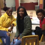 Three high school girls smile as they volunteer for the blood drive