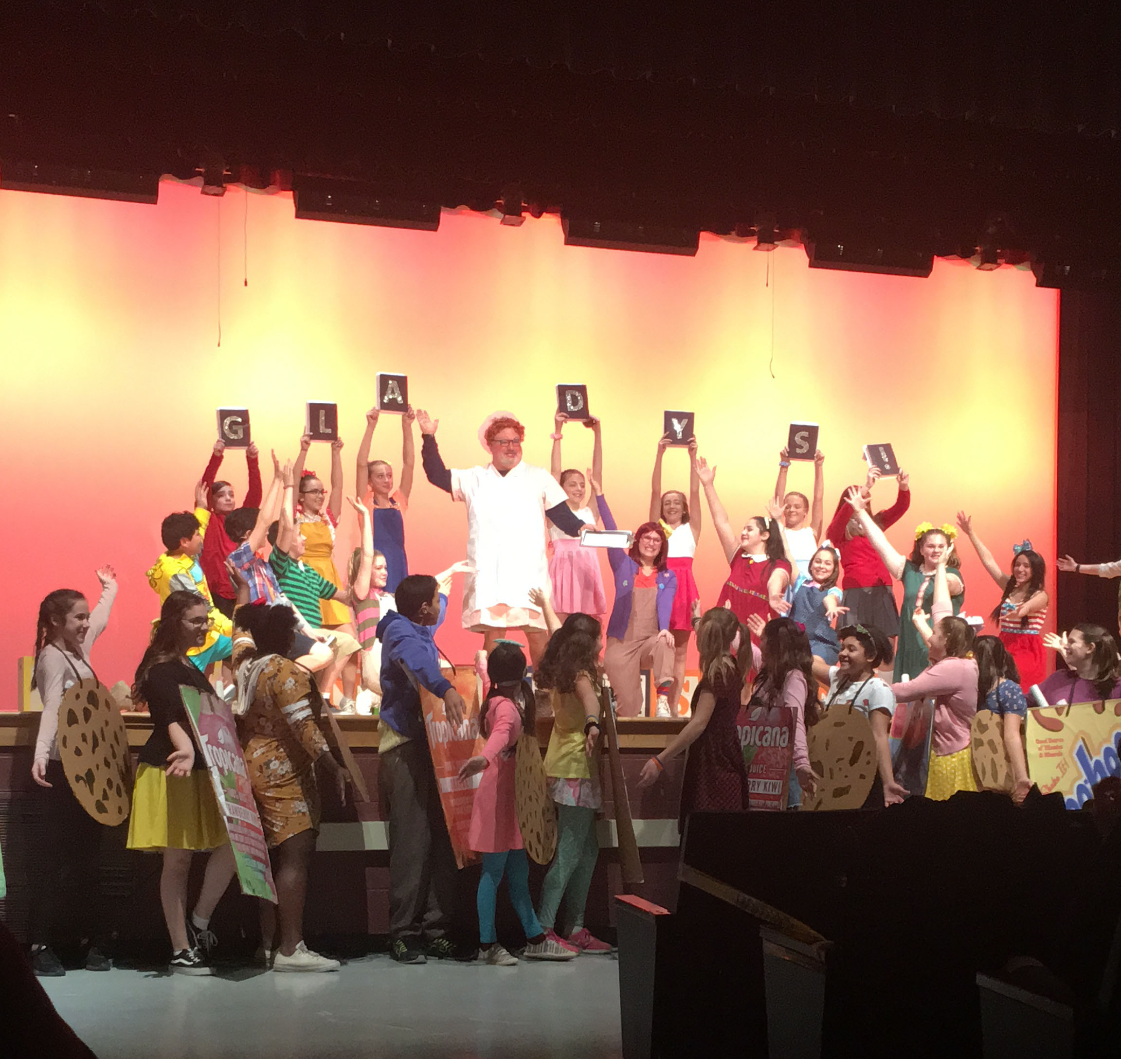 The entire cast plus their principal dressed as a lunch lady