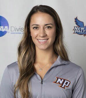 A young woman with long dark blone hair smiles. She is wearing a New Paltz shirt in gray.