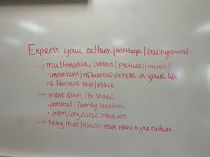 A white board with writing in red on it.