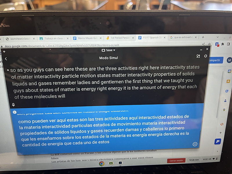 This is a picture of a Chromebook. the top half of the screen is black with white writing in English and the bottom is blue with white type in Spanish.