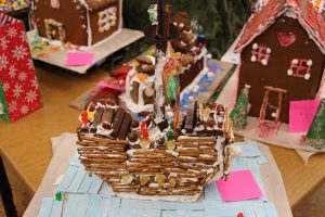 A gingerbread house that is a ship! It has lots of pretzels on the sides to indicate wood and lots of candies and chocolates.