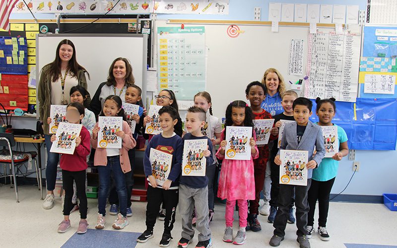 Five students put their handprint signatures on No Place For Hate bulletin board