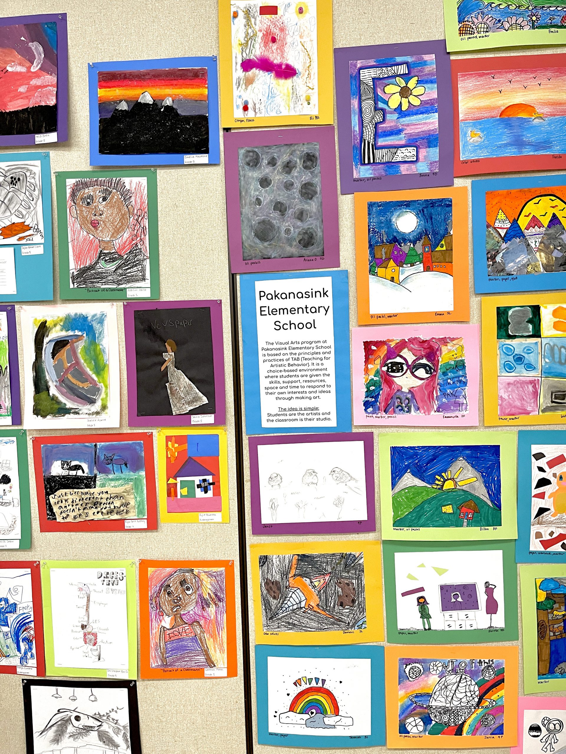 A full wall filled with artwork by elementary students.