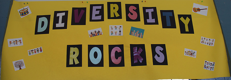 A large yellow banner with the words Diversity Rocks in individual letters of different colors.