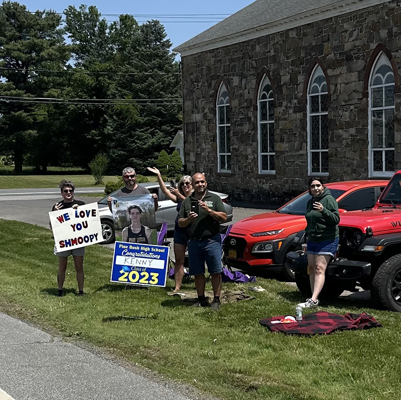 A group of residents with chairs hold signs that says Seniors 2023.