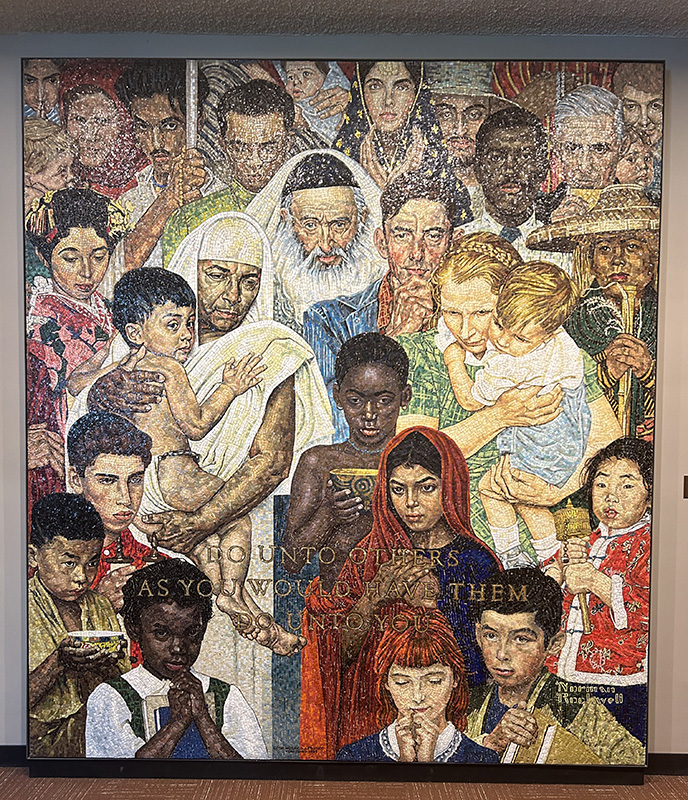A large colorful mosaic showing a big group of people, all different colors, dressed in many different ways. It's a famous Norman Rockwell piece of art.