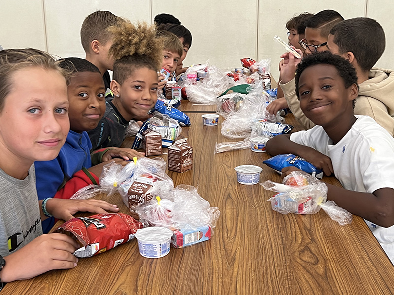 A table of sixth-grade boys having a snack.