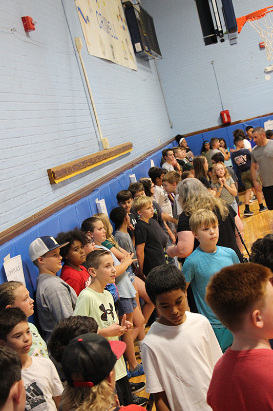 A large group of middle school students in a gym.