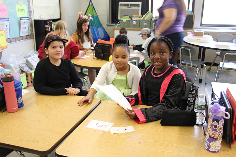 Three fourth-graders work together to design wings for their bat to fly.