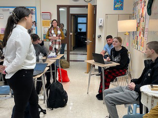 A young woman makes her point to other high school students in a mock trial.