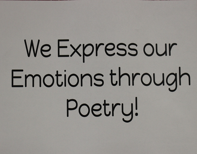 A sign that says in black and white background We Express Our Emotions through Poetry!