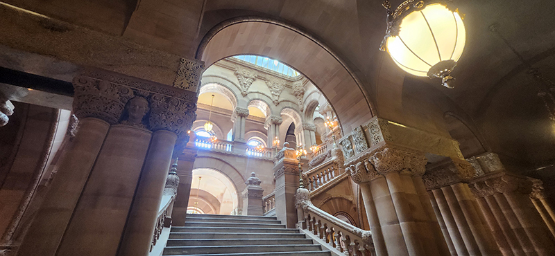 A grand staircase of marble under an arched ceiling.