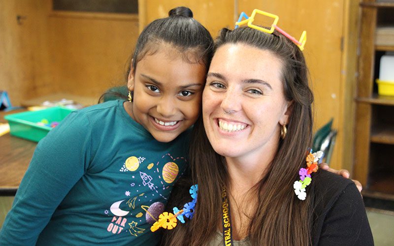 Three elementary girls smiling