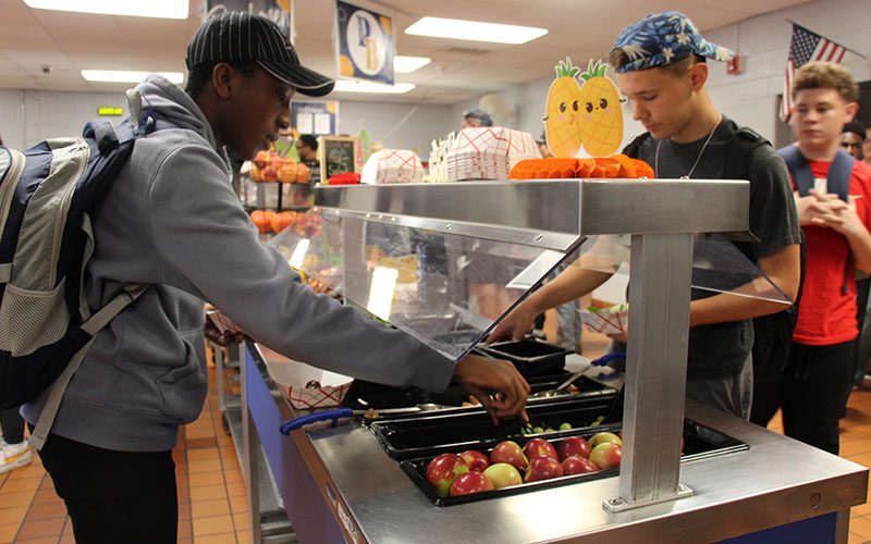 PBHS Food services kids at the salad bar Two high school boys are at a salad bar getting lunch.