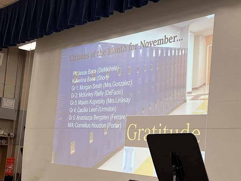 A large slide that lists names of students as students of the month.