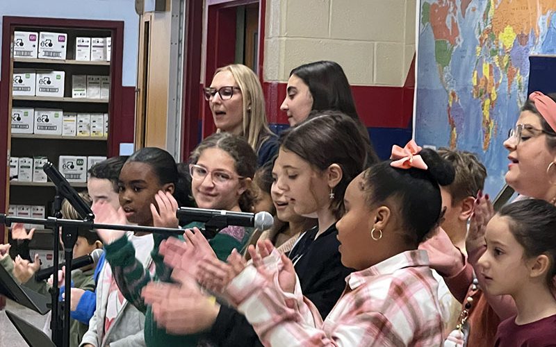 Smiling boy holding homemade boat