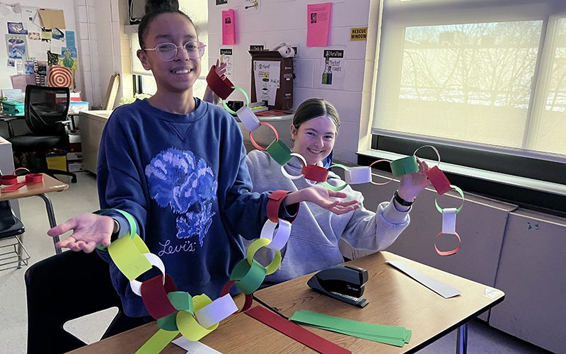 Middle school students dressed as chimney sweeps dance in Mary Poppins Jr.