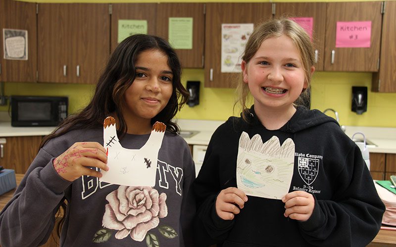 Young woman veteran talks to middle school students about her service