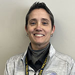 A woman with short dark hair smiles.