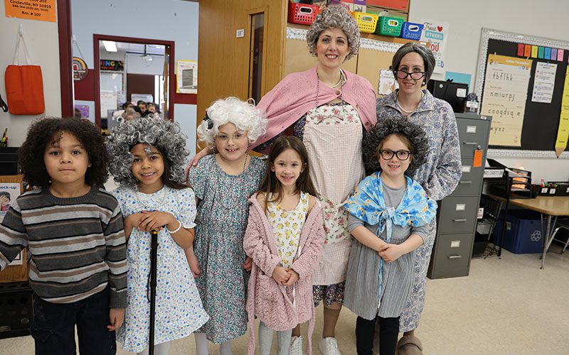Smiling boy holding homemade boat