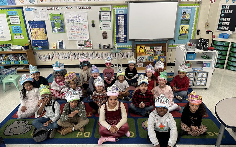 PAK Three girls smiling Three girls smiling as they arrive at Pakanasink Elementary School