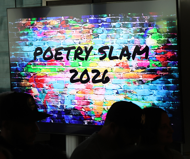 A background of multi-colored bricks. On it reads Poetry Slam 2026.