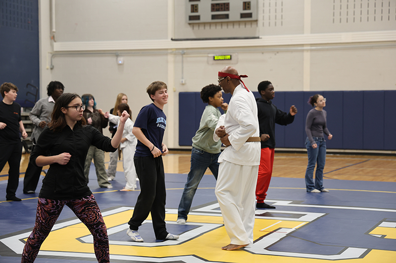 A group of high school kids learn Karate.