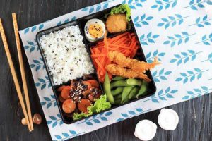 A box with several compartments that contain different foods in each.