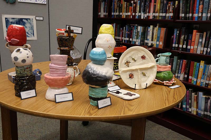 Pottery on a table. All different types, plates, cups, figures.