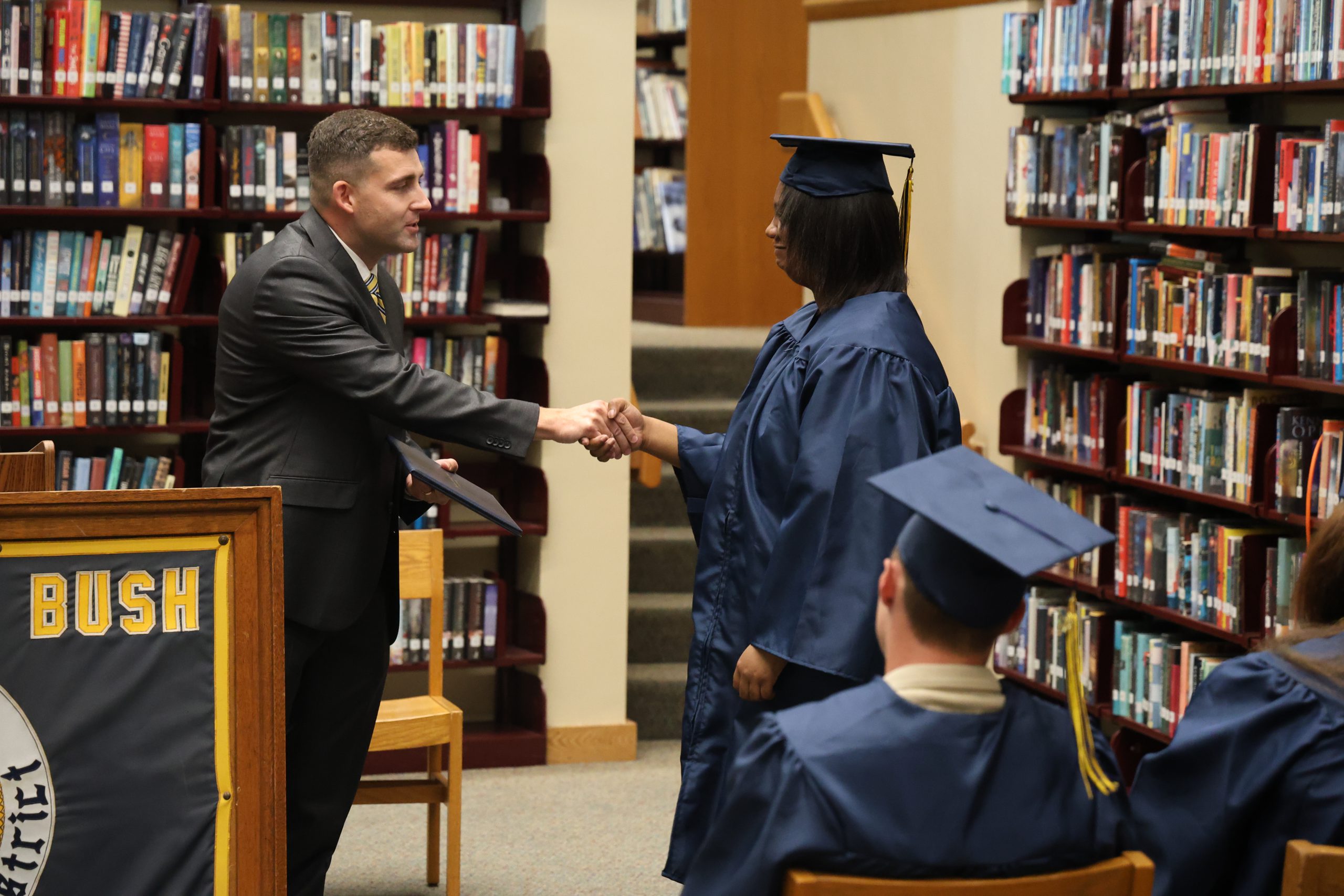administrator shaking a graduates hand
