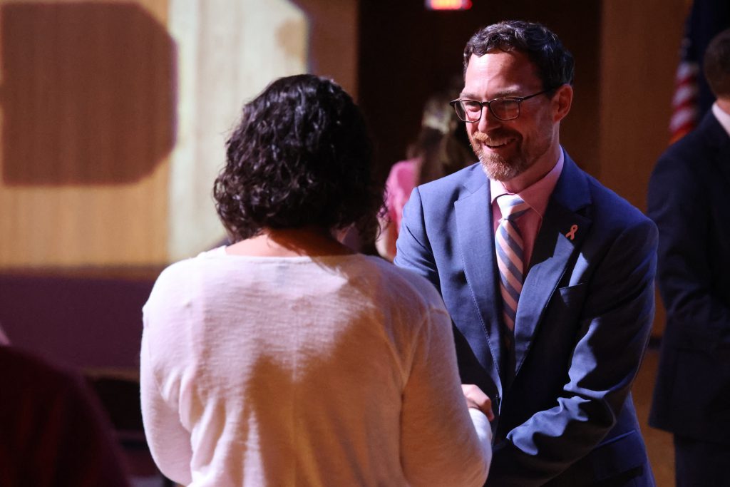 a man is presenting an award to a woman