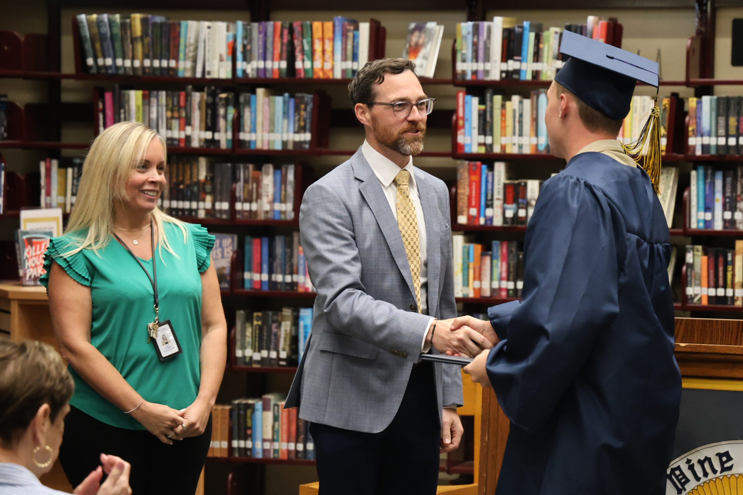 administrator shaking hands with graduate