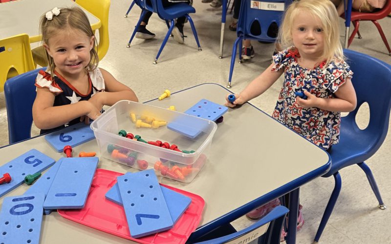 kids at their desk playing with blocks