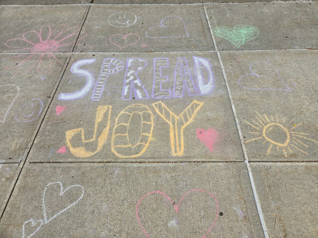 sidewalk art that says spread joy