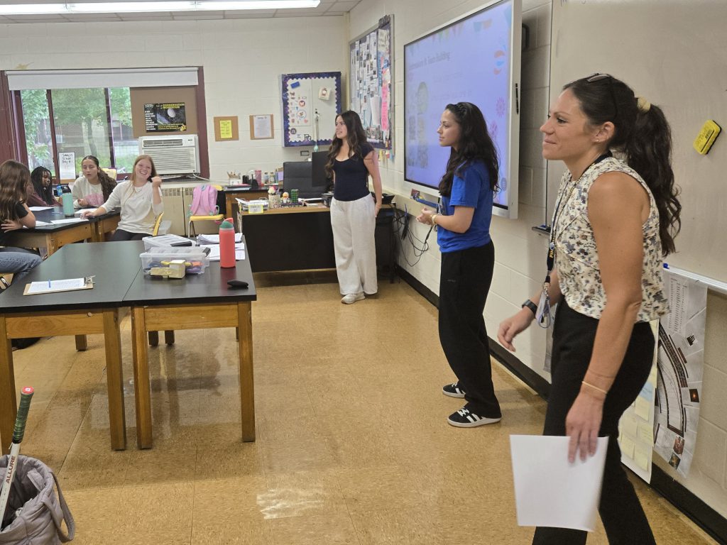 teacher speaking with students