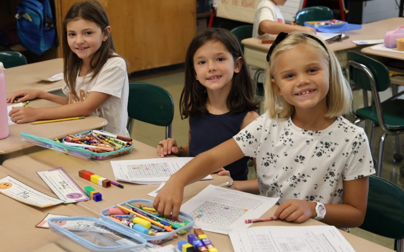 Three elementary girls smiling