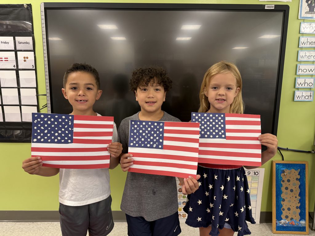 kids holding american flags