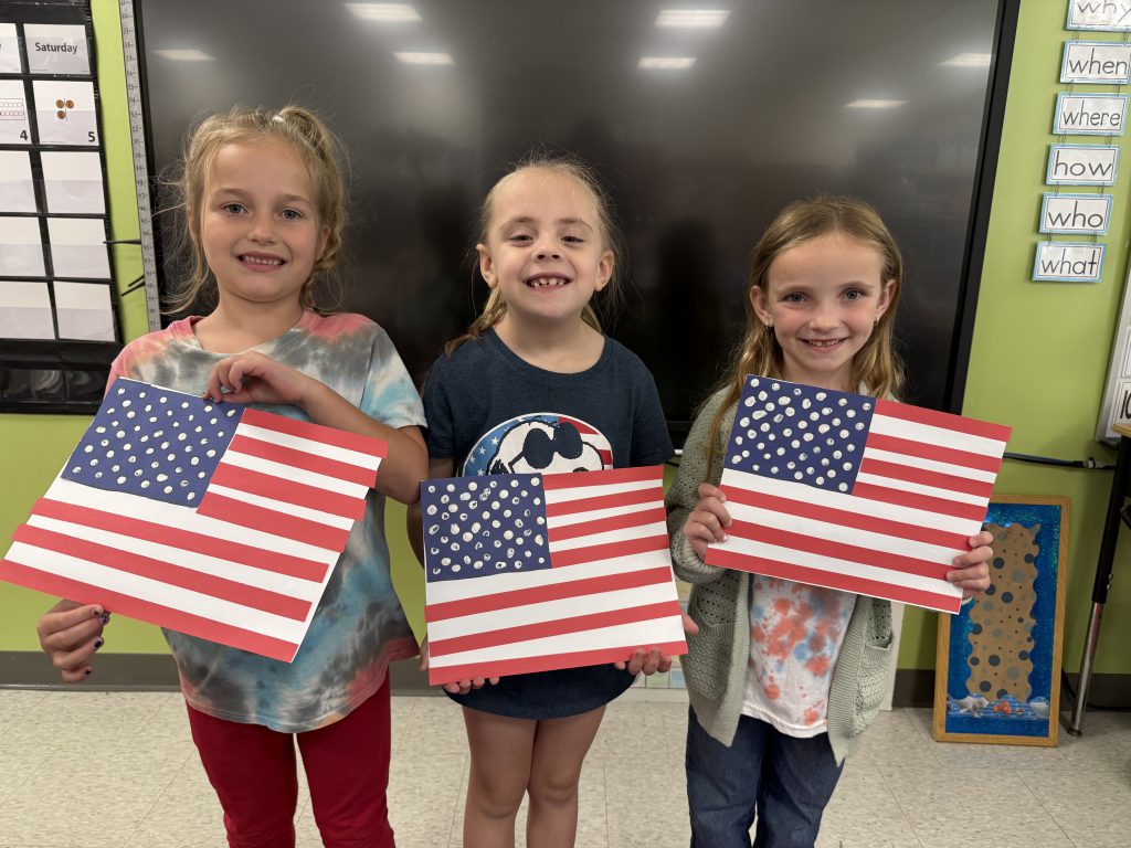 kids holding american flags