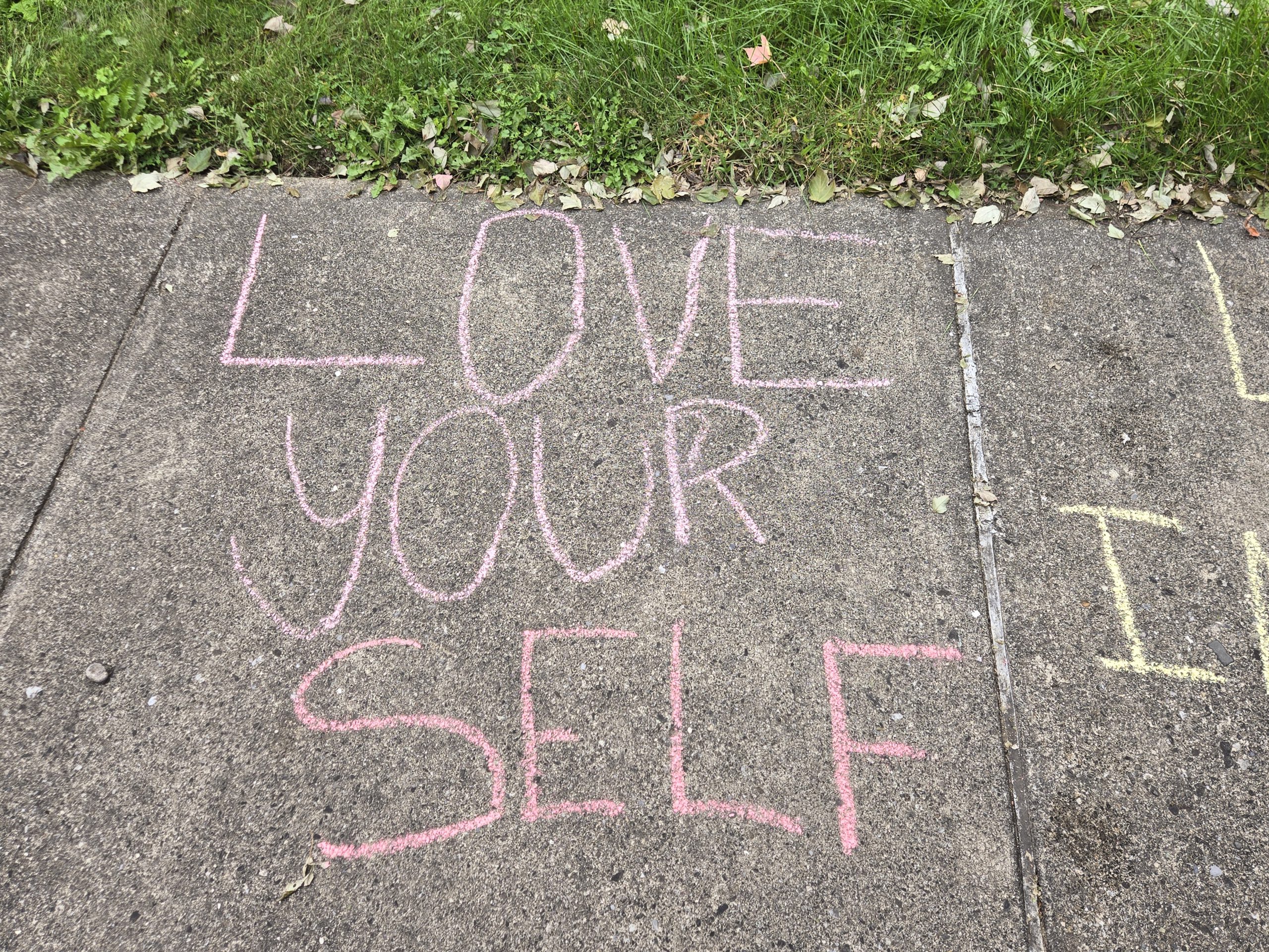 chalk message that says love yourself