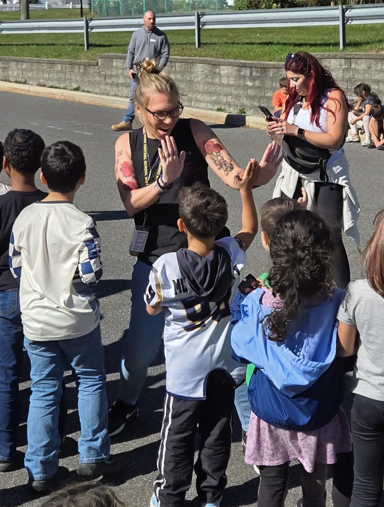 teacher giving high fives to students