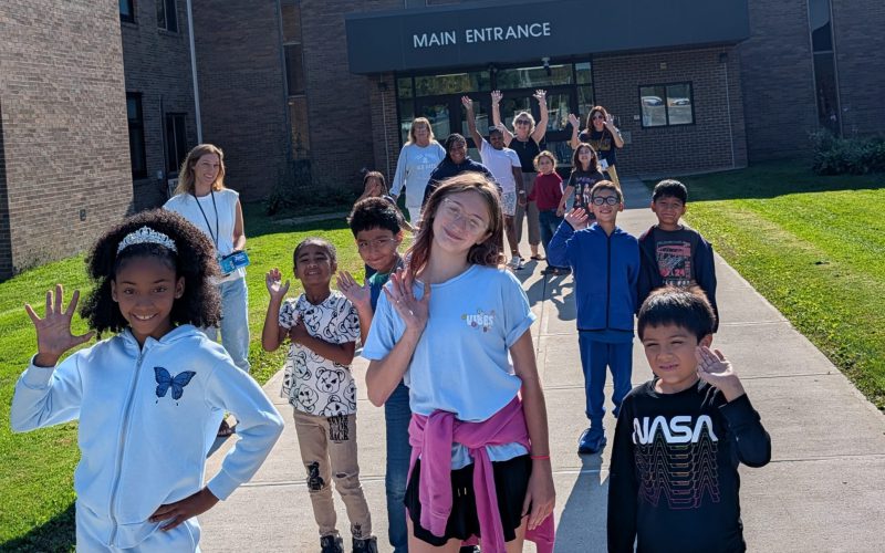 group of kids standing outside of their elementary school