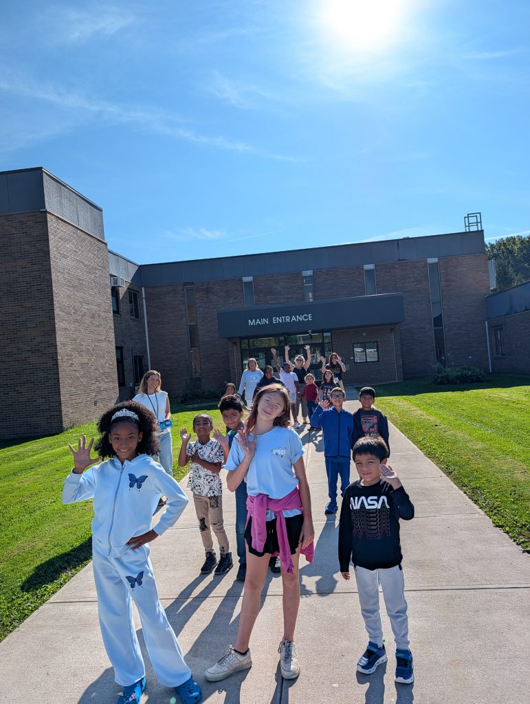 kids outside the main entrance of their school
